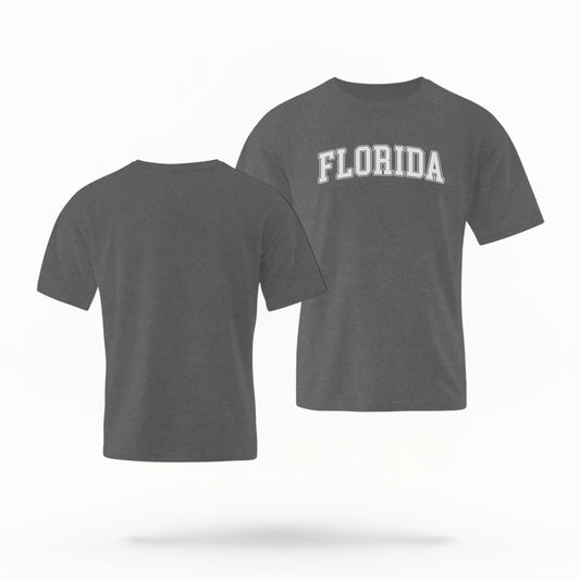 The pepper Adult Unisex Florida Varsity Comfort Colors T-shirt lays flat on a white background. The Florida graphic is in bold white in a varsity offset style.