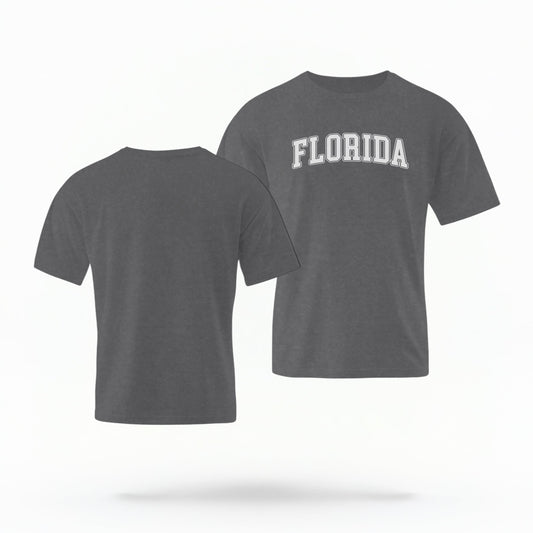 The pepper Adult Unisex Florida Varsity Comfort Colors T-shirt lays flat on a white background. The Florida graphic is in bold white in a varsity offset style.
