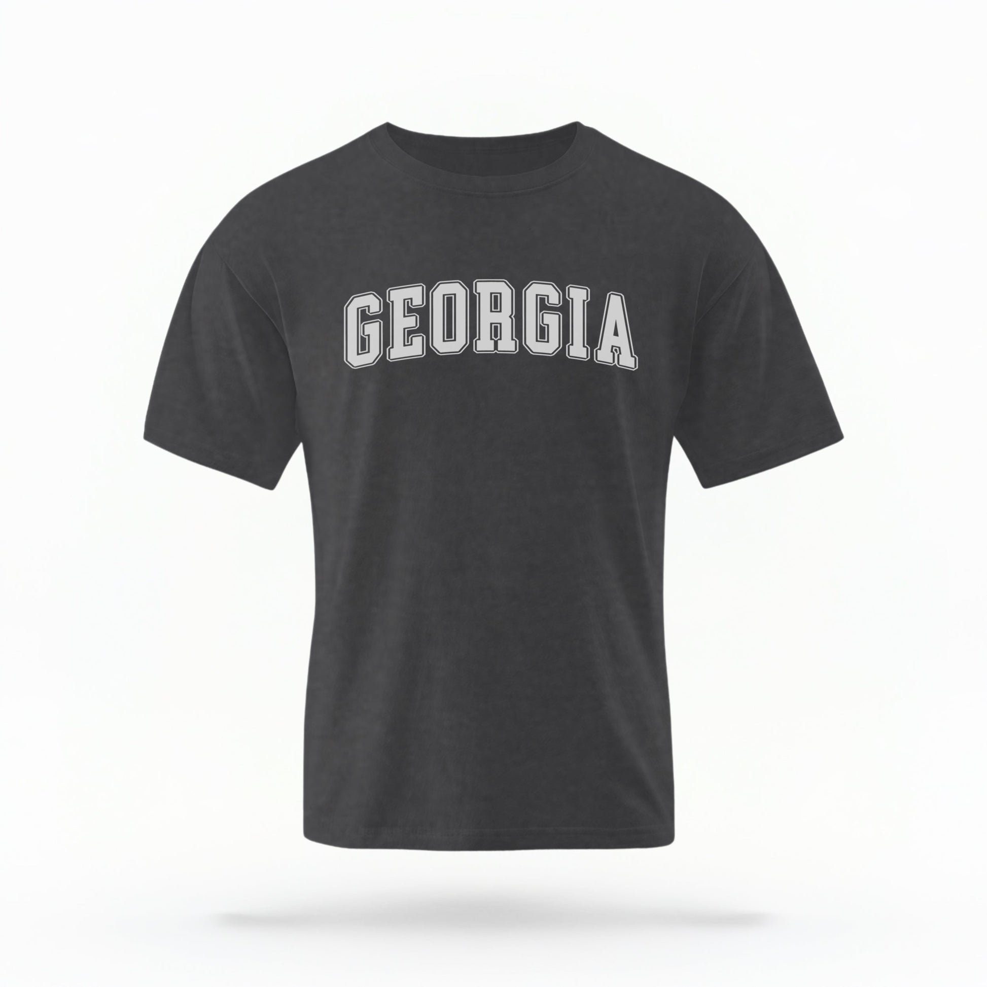 The Pepper Unisex Georgia Varsity Comfort Colors T-shirt lays flat on a white background. The Georgia graphic is in bold white in a varsity offset style.