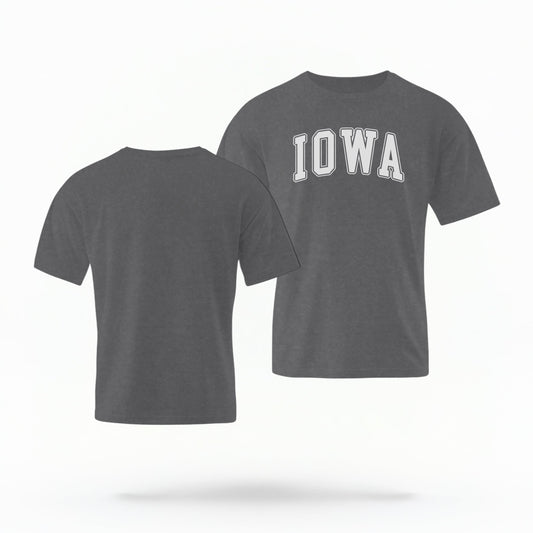 The Pepper Unisex Iowa Varsity Comfort Colors T-shirt lays flat on a white background. The Iowa graphic is in bold white in a varsity offset style.