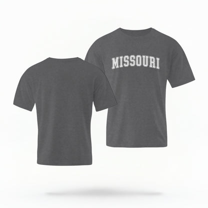 The Pepper Unisex Missouri Varsity Comfort Colors T-shirt lays flat on a white background. The Missouri graphic is in bold white in a varsity offset style.