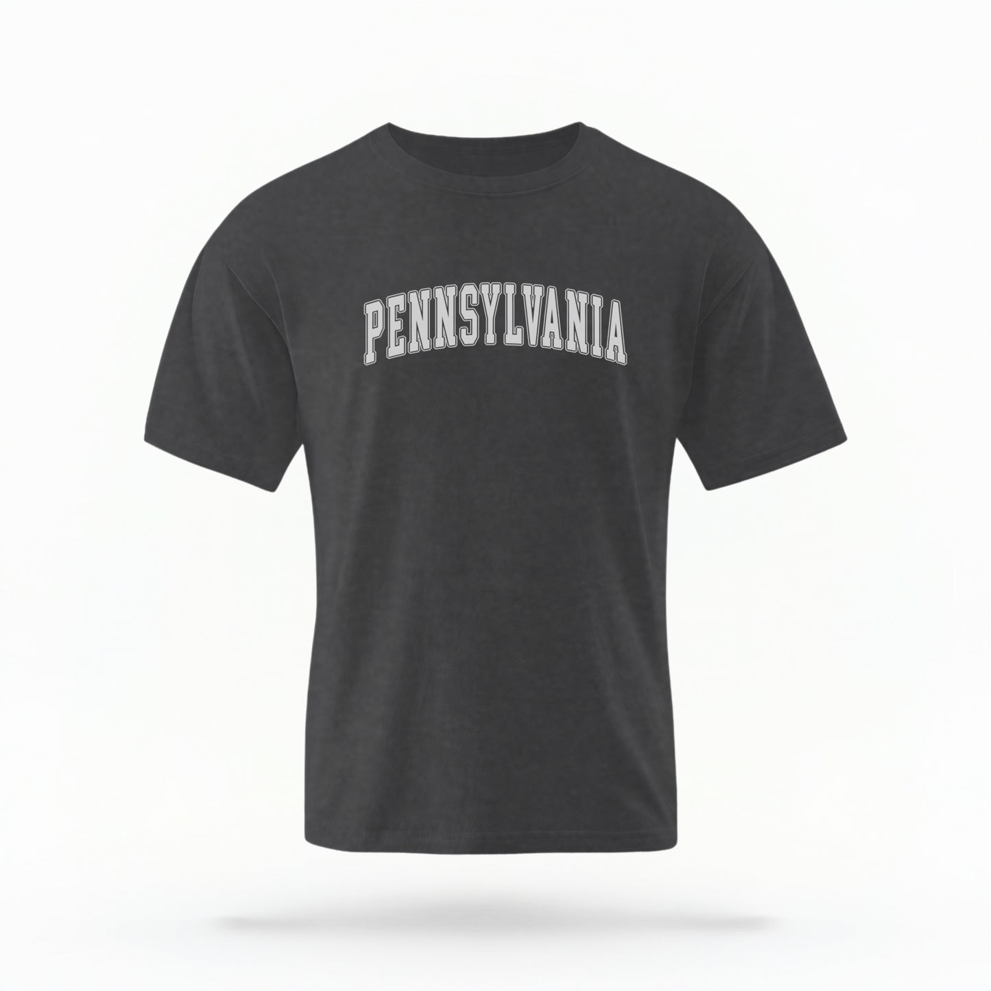 The Pepper Unisex Pennsylvania Varsity Comfort Colors T-shirt lays flat on a white background. The Pennsylvania graphic is in bold white in a varsity offset style.