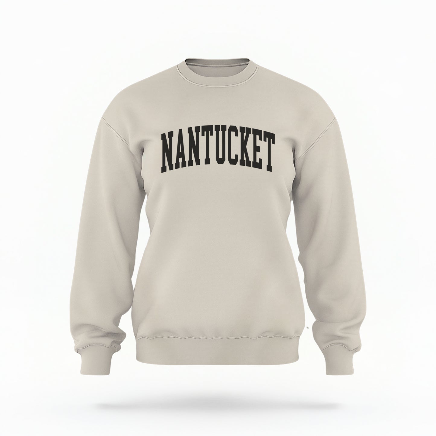 The Sand Unisex Nantucket Varsity Crewneck Sweatshirt lays flat on a white background. The Nantucket graphic is in bold black and varsity offset style.