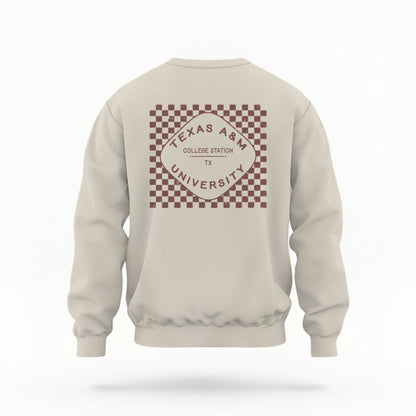 The Sand Texas A&m Retro Typography Crewneck Sweatshirt lays flat on a white background. The ﻿Texas A&m Retro Typography﻿ graphic is in bold Maroon in a Retro style.