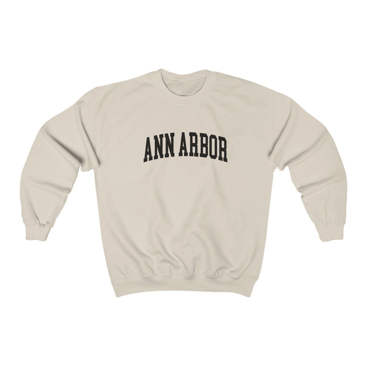 The Sand Adult Unisex Ann Arbor Michigan Varsity Crewneck Sweatshirt lays flat on a white background. The Ann Arbor Michigan Varsity graphic is in bold Black in a Collegiate style.