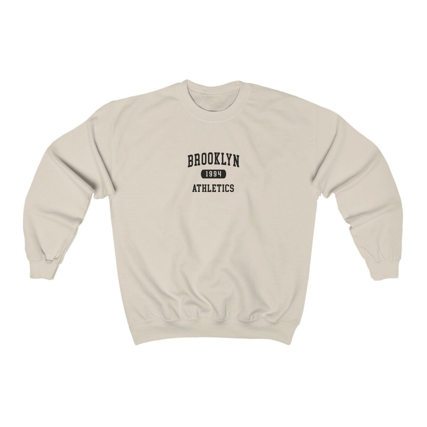 The Sand Brooklyn Athletics Crewneck Sweatshirt lays flat on a white background. The ﻿Brooklyn Athletics﻿ graphic is in bold Navy in a Varsity style.