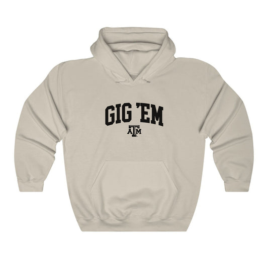 The Sand Adult Unisex Texas A&M Gig 'Em Collegiate Hooded Sweatshirt lays flat on a white background. The ﻿Texas A&M Gig 'Em Collegiate﻿ graphic is in bold Black in a Collegiate style.