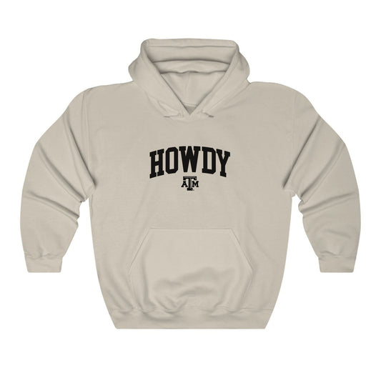 The Sand Adult Unisex Texas A&M Howdy Varsity Hooded Sweatshirt lays flat on a white background. The ﻿Texas A&M Howdy Varsity﻿ graphic is in bold Black in a Collegiate style.