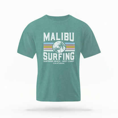 The Seafoam Adult Unisex Malibu California Surfing Comfort Colors T-shirt lays flat on a white background. The ﻿Malibu California Surfing﻿ graphic is in bold Lifestyle in a Multicolor style.