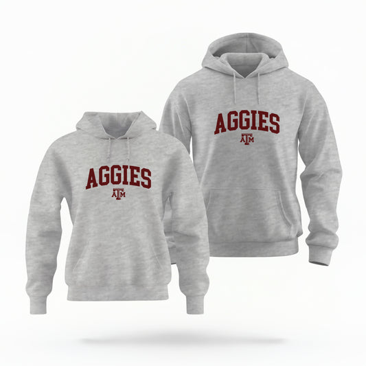 The Sport Grey Adult Unisex Texas A&M Aggies Collegiate Hooded Sweatshirt lays flat on a white background. The ﻿Texas A&M Aggies Collegiate﻿ graphic is in bold Maroon in a Varsity style.