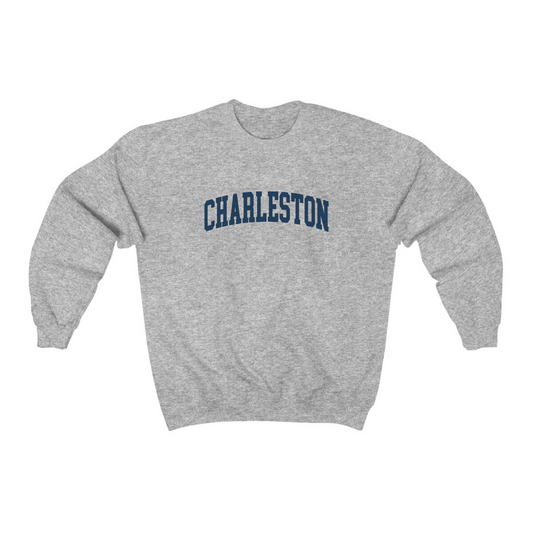 The Sport Grey Adult Unisex Charleston SC Collegiate Crewneck Sweatshirt lays flat on a white background. The ﻿Charleston SC Collegiate﻿ graphic is in bold Navy in a Varsity style.