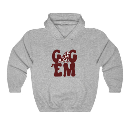 The Sport Grey Adult Unisex Texas A&M Gig 'Em Retro Reveille Hooded Sweatshirt lays flat on a white background. The ﻿Texas A&M Gig 'Em Retro Reveille﻿ graphic is in bold Maroon in a Groovy Vintage style.