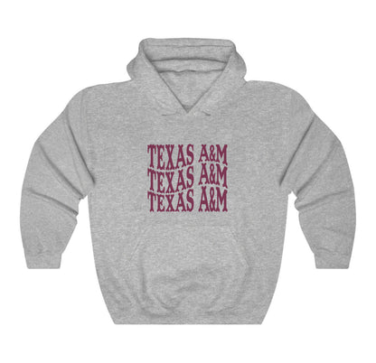 The Sport Grey Adult Unisex Texas A&M Western Hooded Sweatshirt lays flat on a white background. The ﻿Texas A&M Western﻿ graphic is in bold Maroon in a Western style.