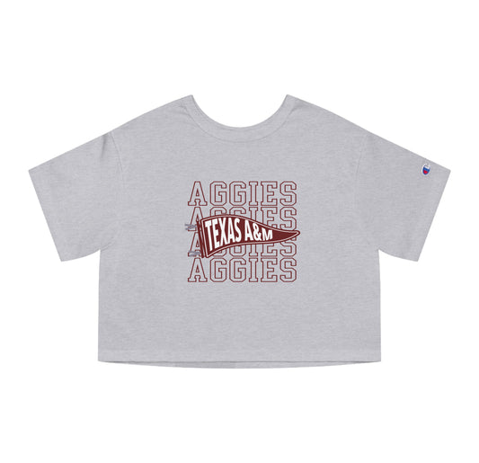 The Oxford Grey Adult Womens Texas A&M Aggies Pennant Crop Top lays flat on a white background. The ﻿Texas A&M Aggies Pennant﻿ graphic is in bold Maroon in a Varsity style.