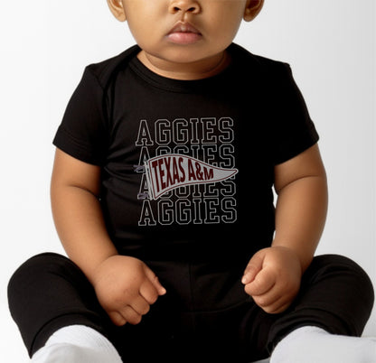 A model wears the Black Infant Unisex Texas A&M Aggies Pennant Bodysuit.  The ﻿Texas A&M Aggies Pennant﻿ graphic is in bold White in a Varsity style.