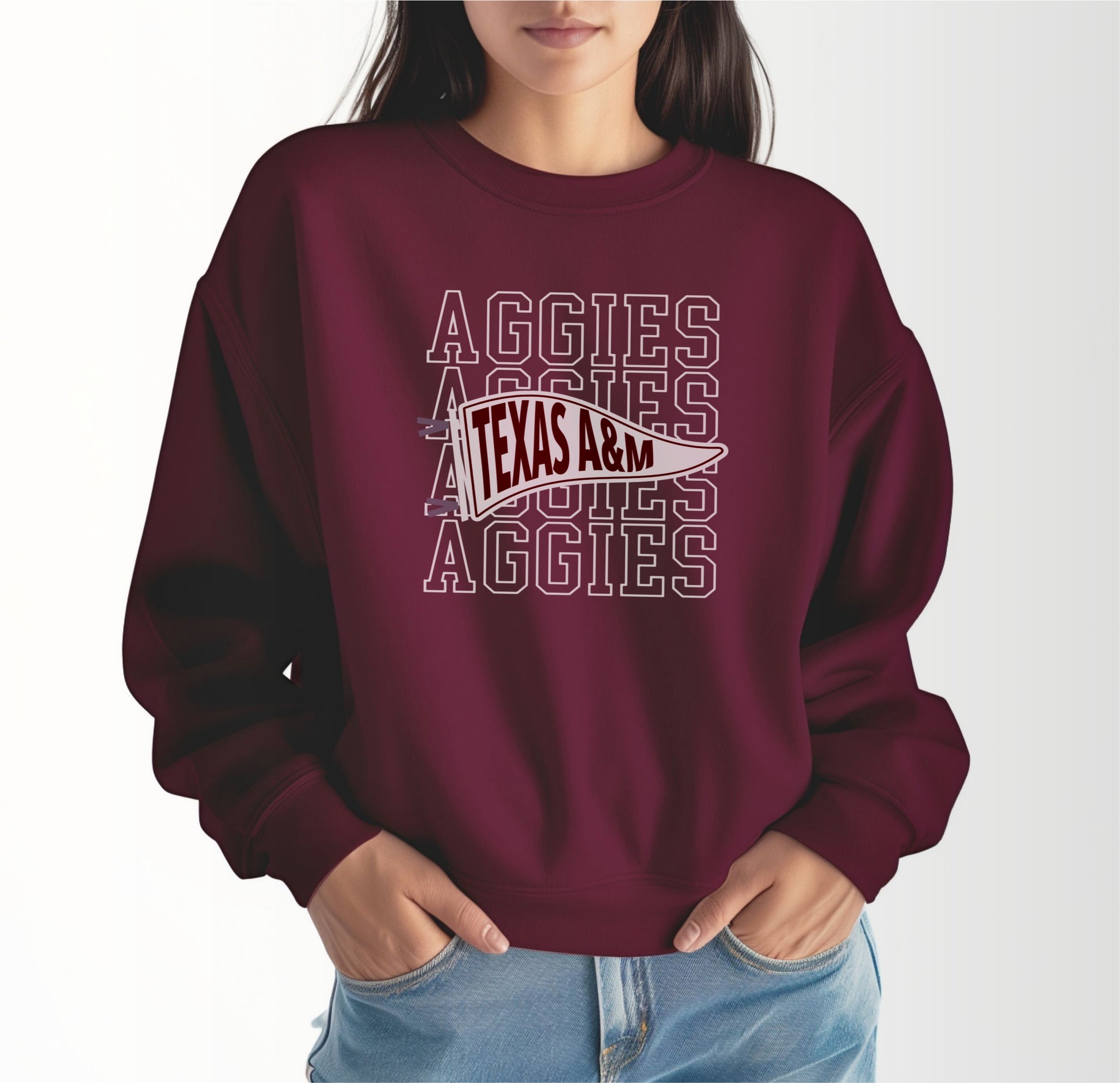 A model wears the Maroon Adult Unisex Texas A&M Aggies Pennant Crewneck Sweatshirt.  The ﻿Texas A&M Aggies Pennant﻿ graphic is in bold White in a Varsity style.