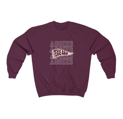 The Maroon Adult Unisex Texas A&M Aggies Pennant Crewneck Sweatshirt lays flat on a white background. The ﻿Texas A&M Aggies Pennant﻿ graphic is in bold White in a Varsity style.