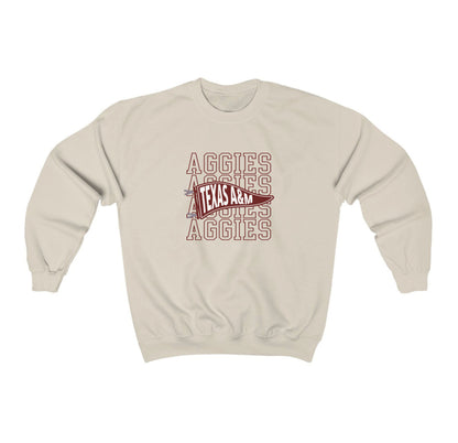 The Sand Adult Unisex Texas A&M Aggies Pennant Crewneck Sweatshirt lays flat on a white background. The ﻿Texas A&M Aggies Pennant﻿ graphic is in bold Black in a Varsity style.