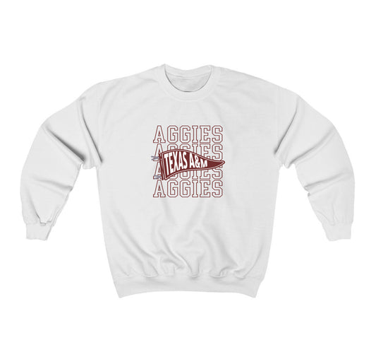 The White Adult Unisex Texas A&M Aggies Pennant Crewneck Sweatshirt lays flat on a white background. The ﻿Texas A&M Aggies Pennant﻿ graphic is in bold Maroon in a Varsity style.