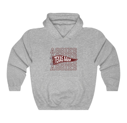 The Sport Grey Adult Unisex Texas A&M Aggies Pennant Hooded Sweatshirt lays flat on a white background. The ﻿Texas A&M Aggies Pennant﻿ graphic is in bold Maroon in a Varsity style.