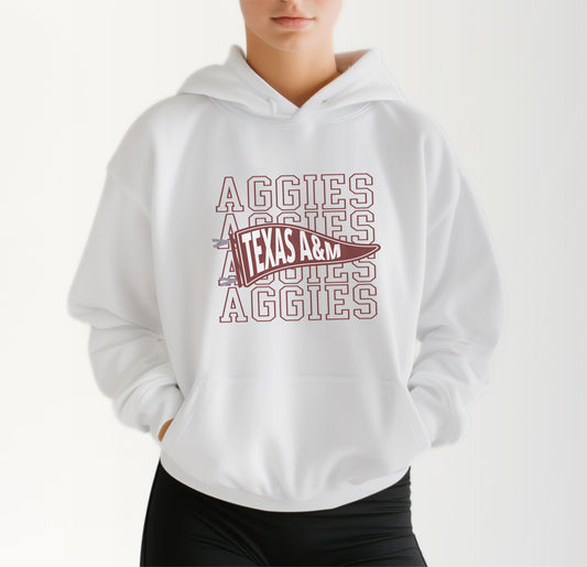 A model wears the White Adult Unisex Texas A&M Aggies Pennant Hooded Sweatshirt.  The ﻿Texas A&M Aggies Pennant﻿ graphic is in bold Maroon in a Varsity style.