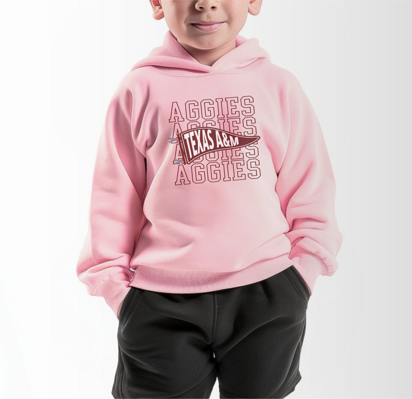 A model wears the Pink Toddler Unisex Texas A&M Aggies Pennant Hooded Sweatshirt.  The ﻿Texas A&M Aggies Pennant﻿ graphic is in bold White in a Varsity style.