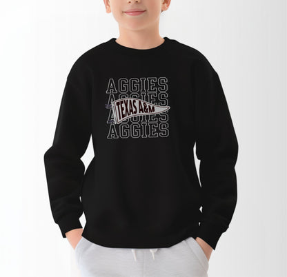 A model wears the Black Youth Unisex Texas A&M Aggies Pennant Crewneck Sweatshirt.  The ﻿Texas A&M Aggies Pennant﻿ graphic is in bold White in a Varsity style.