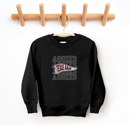 The Black Youth Unisex Texas A&M Aggies Pennant Crewneck Sweatshirt lays flat on a white background. The ﻿Texas A&M Aggies Pennant﻿ graphic is in bold White in a Varsity style.