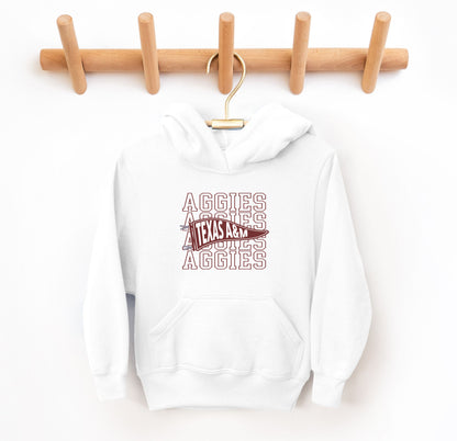 The White Youth Unisex Texas A&M Aggies Pennant Hooded Sweatshirt lays flat on a white background. The ﻿Texas A&M Aggies Pennant﻿ graphic is in bold Maroon in a Varsity style.