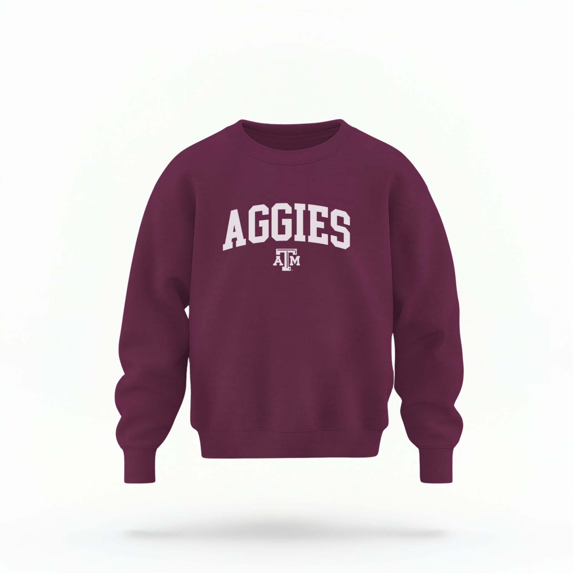 The Maroon Youth Unisex Texas A&M Aggies Collegiate Crewneck Sweatshirt lays flat on a white background. The ﻿Texas A&M Aggies Collegiate﻿ graphic is in bold White in a Varsity style.