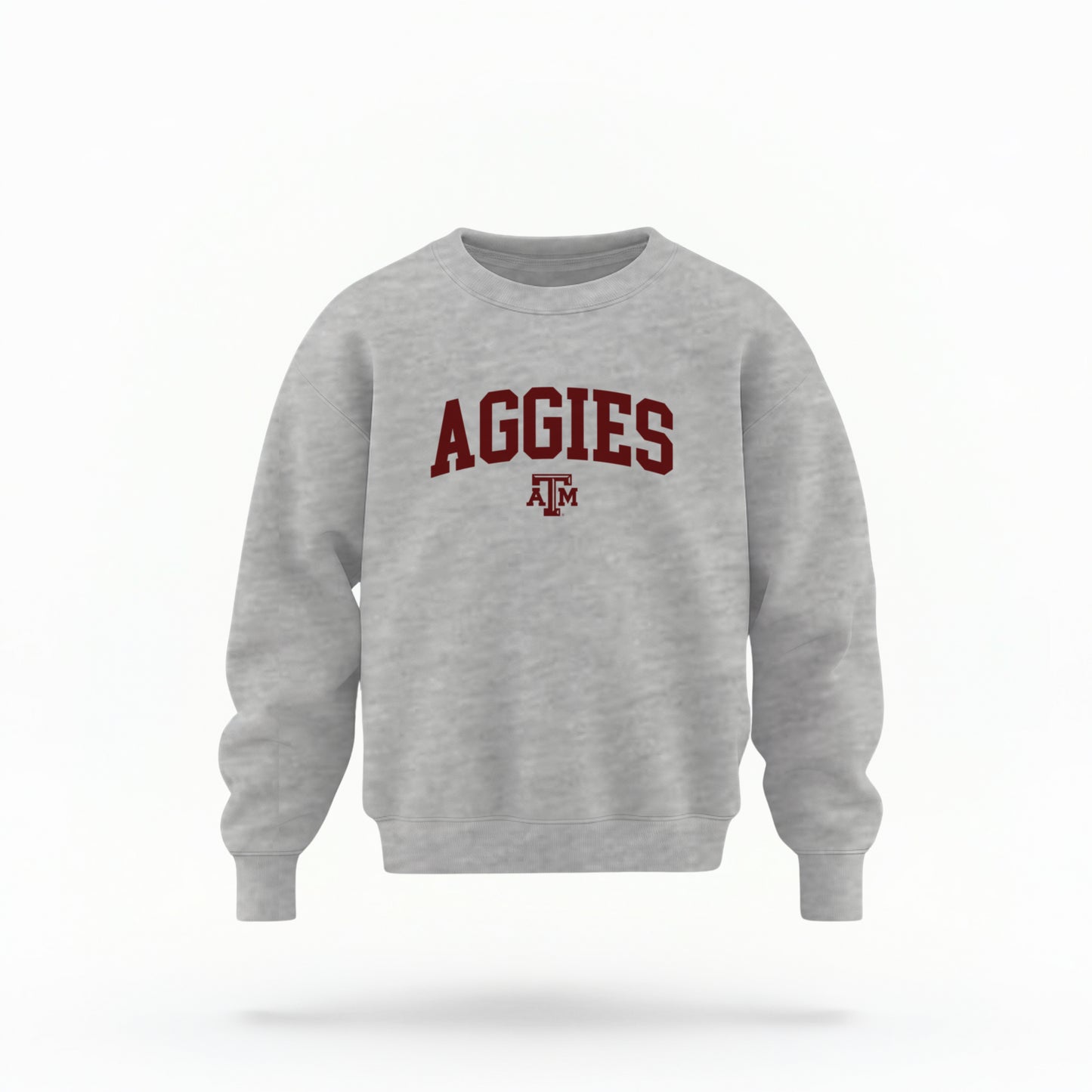 The Sport Grey Youth Unisex Texas A&M Aggies Collegiate Crewneck Sweatshirt lays flat on a white background. The ﻿Texas A&M Aggies Collegiate﻿ graphic is in bold Maroon in a Varsity style.