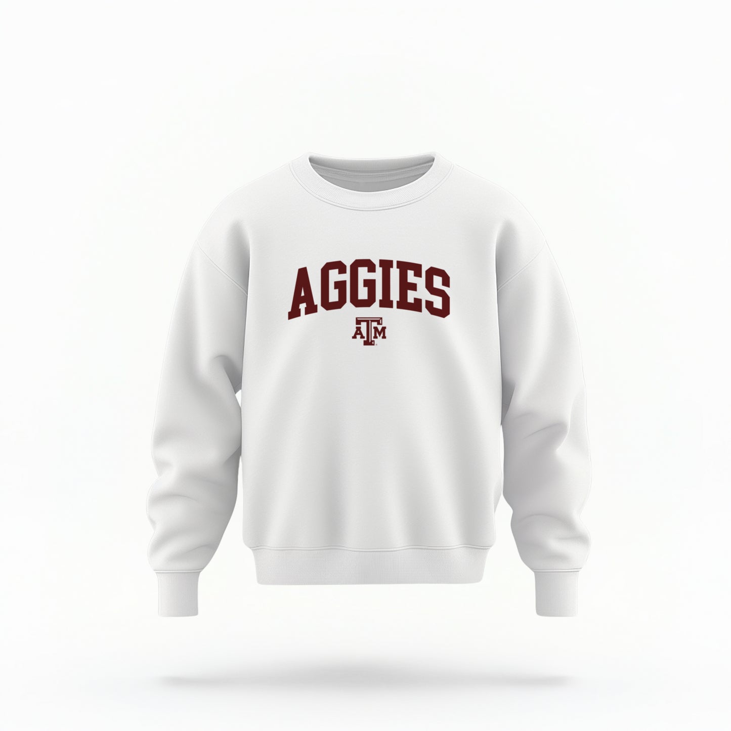 The White Youth Unisex Texas A&M Aggies Collegiate Crewneck Sweatshirt lays flat on a white background. The ﻿Texas A&M Aggies Collegiate﻿ graphic is in bold Maroon in a Varsity style.