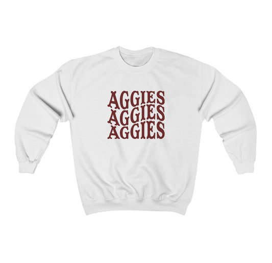 The White Adult Unisex Texas A&M Aggies Aggies Aggies Western Crewneck Sweatshirt lays flat on a white background. The ﻿Texas A&M Aggies Aggies Aggies Western﻿ graphic is in bold Maroon in a Western style.