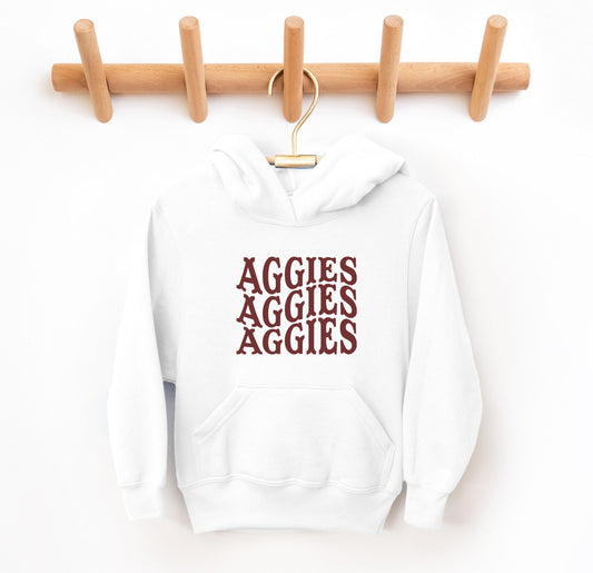 The White Youth Unisex Texas A&M Aggies Aggies Aggies Western Hooded Sweatshirt lays flat on a white background. The ﻿Texas A&M Aggies Aggies Aggies Western﻿ graphic is in bold Maroon in a Western style.