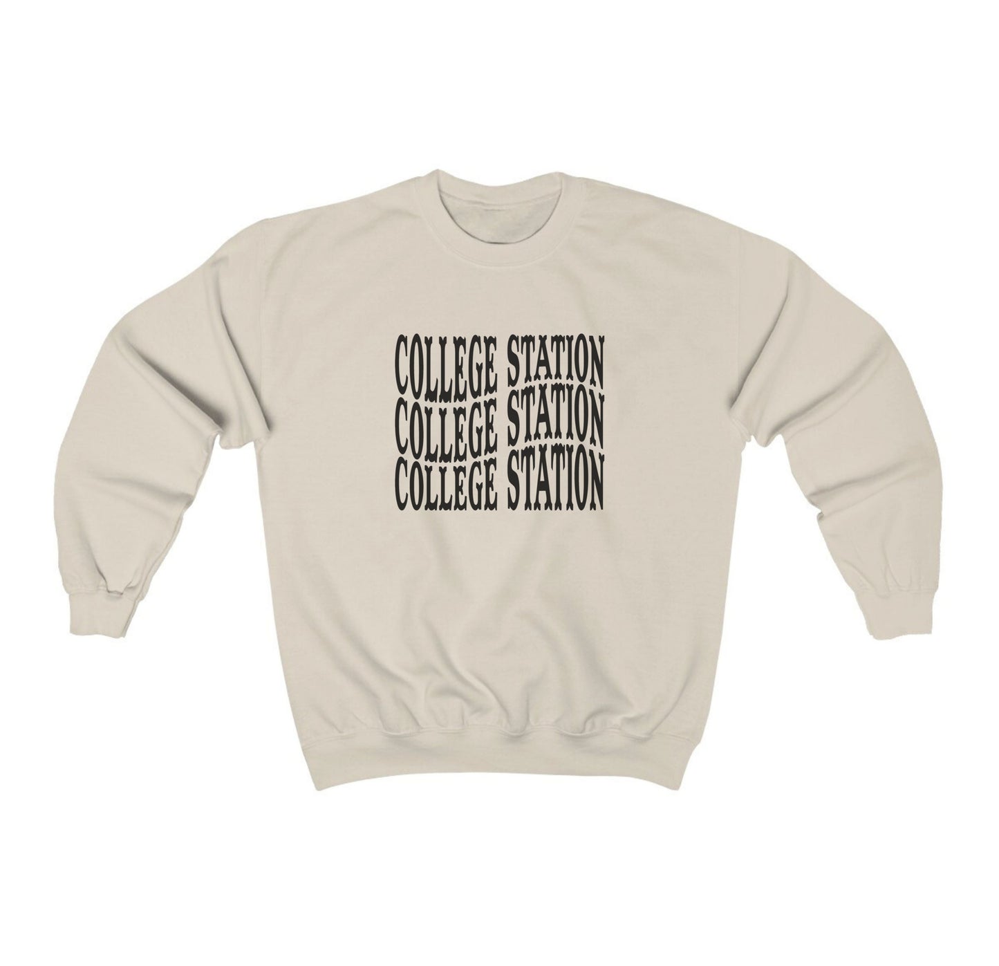 The Sand Adult Unisex College Station Western Crewneck Sweatshirt lays flat on a white background. The ﻿College Station Western﻿ graphic is in bold Black in a Western style.