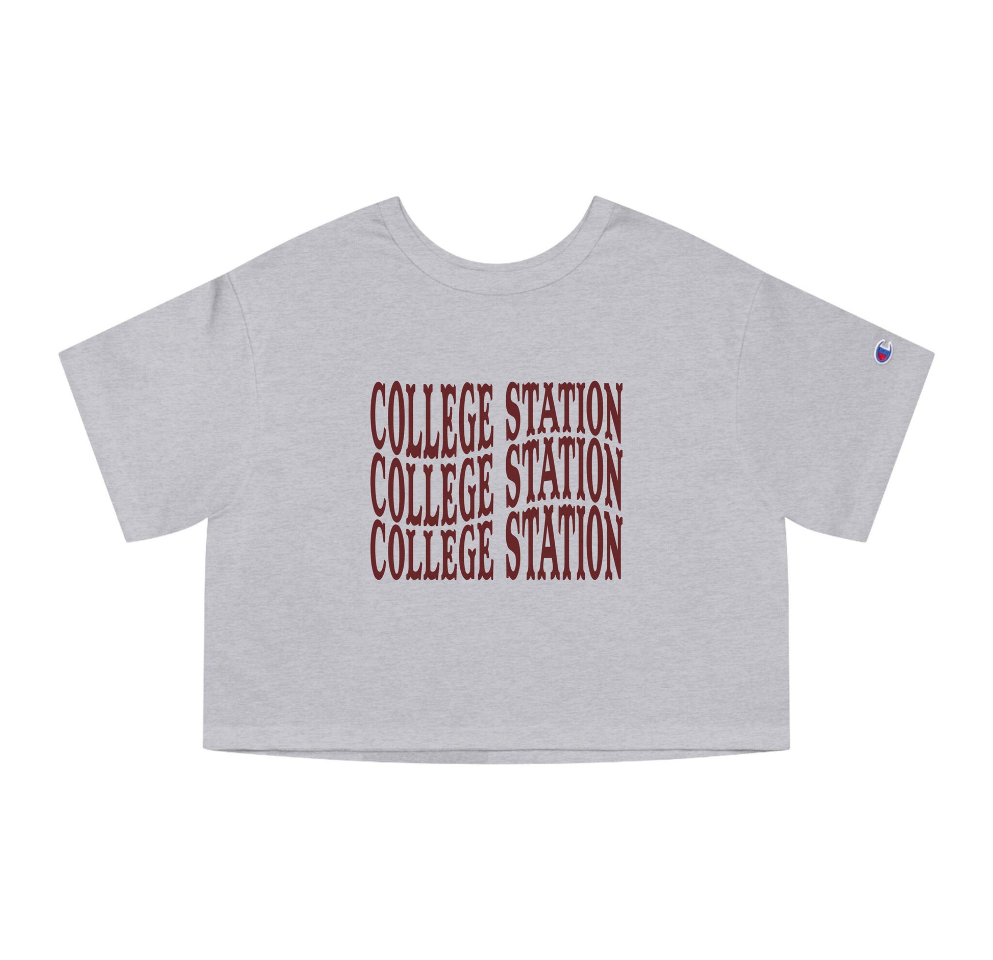 The Oxford Grey Adult Womens College Station Western Crop Top lays flat on a white background. The ﻿College Station Western﻿ graphic is in bold Maroon in a Western style.