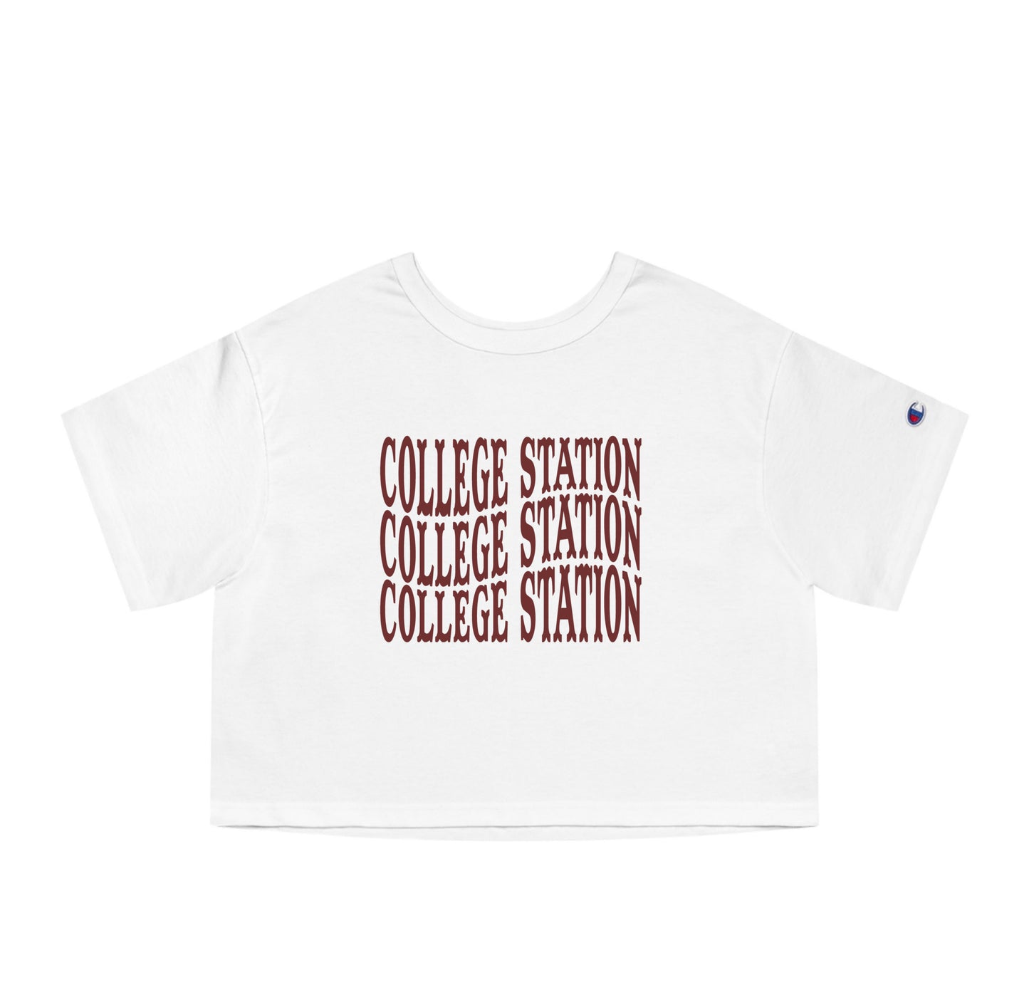 The White Adult Womens College Station Western Crop Top lays flat on a white background. The ﻿College Station Western﻿ graphic is in bold Maroon in a Western style.