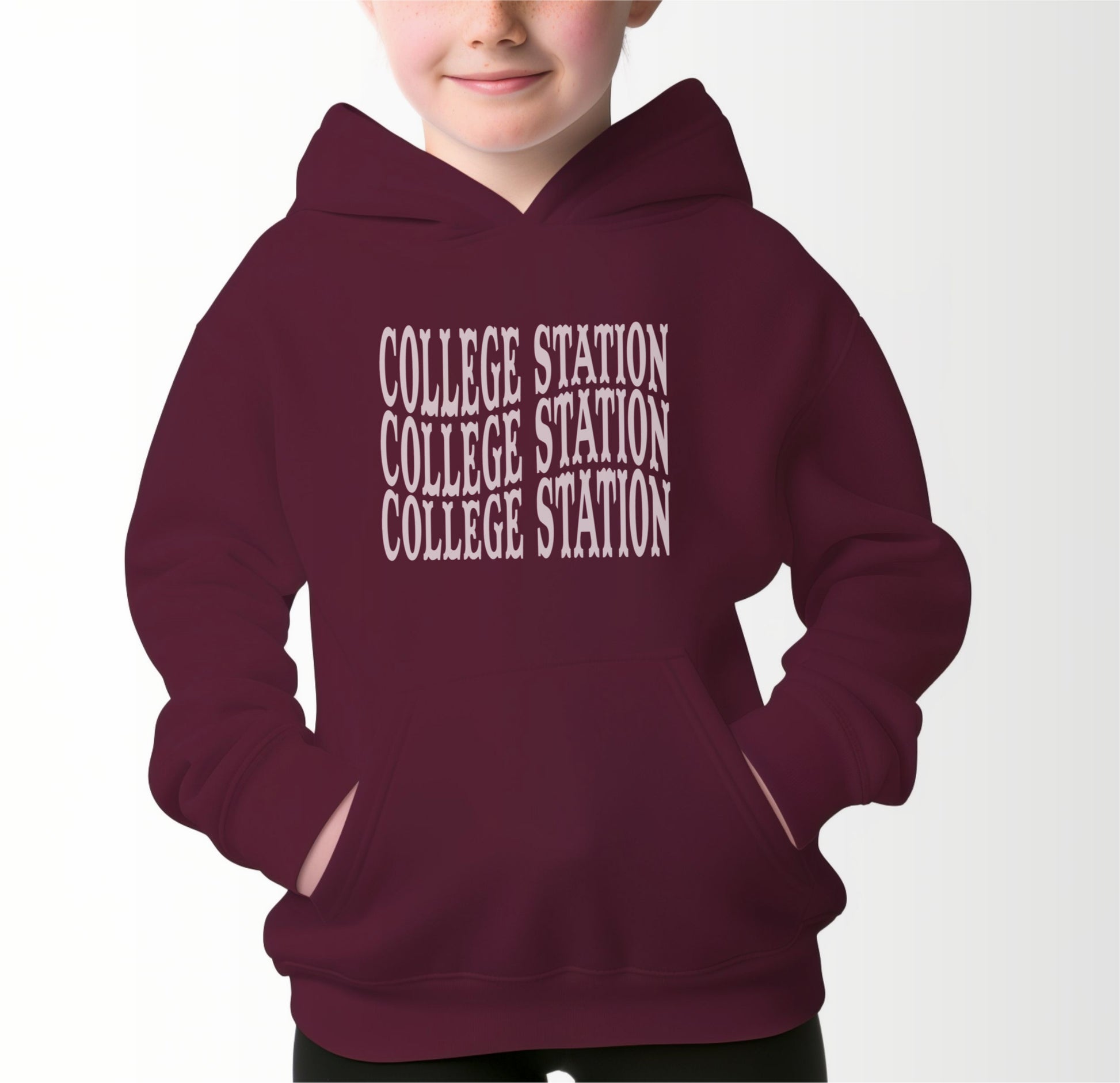 A model wears the Maroon Youth Unisex College Station Western Hooded Sweatshirt.  The ﻿College Station Western﻿ graphic is in bold White in a Western style.