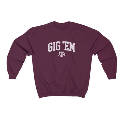 The Maroon Adult Unisex Texas A&M Gig 'Em Collegiate Crewneck Sweatshirt lays flat on a white background. The ﻿Texas A&M Gig 'Em Collegiate﻿ graphic is in bold White in a Collegiate style.