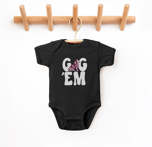 The Black Infant Unisex Texas A&M Gig 'Em Retro Reveille Bodysuit lays flat on a white background. The ﻿Texas A&M Gig 'Em Retro Reveille﻿ graphic is in bold White in a Groovy Vintage style.