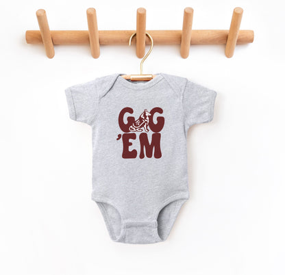 The Heather Grey Infant Unisex Texas A&M Gig 'Em Retro Reveille Bodysuit lays flat on a white background. The ﻿Texas A&M Gig 'Em Retro Reveille﻿ graphic is in bold Maroon in a Groovy Vintage style.