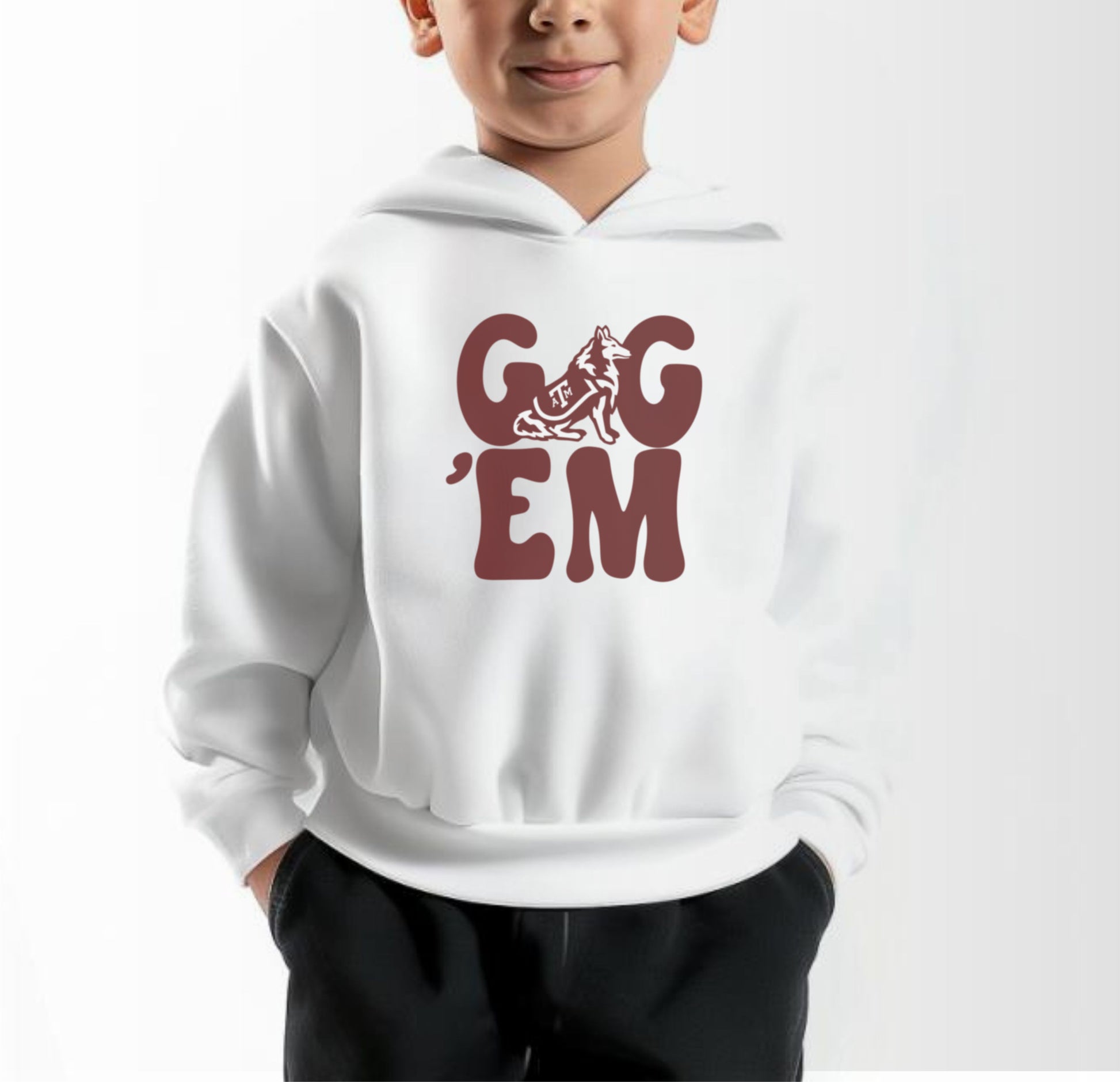 A model wears the White Toddler Unisex Texas A&M Gig 'Em Retro Reveille Hooded Sweatshirt.  The ﻿Texas A&M Gig 'Em Retro Reveille﻿ graphic is in bold Maroon in a Groovy Vintage style.