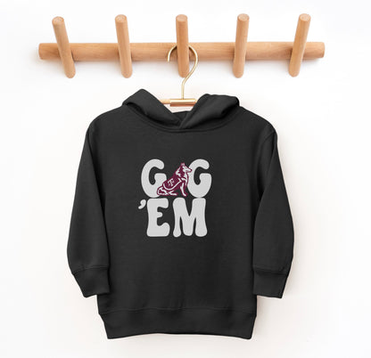 The Black Toddler Unisex Texas A&M Gig 'Em Retro Reveille Hooded Sweatshirt lays flat on a white background. The ﻿Texas A&M Gig 'Em Retro Reveille﻿ graphic is in bold White in a Groovy Vintage style.