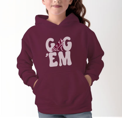 A model wears the Maroon Youth Unisex Texas A&M Gig 'Em Retro Reveille Hooded Sweatshirt.  The ﻿Texas A&M Gig 'Em Retro Reveille﻿ graphic is in bold White in a Groovy Vintage style.