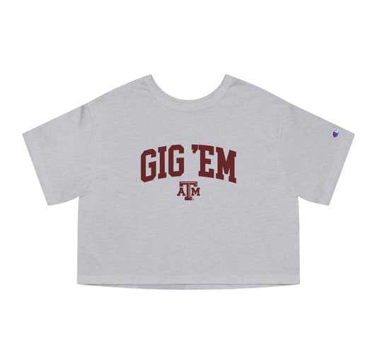 The Oxford Grey Adult Womens Texas A&M Gig 'Em Collegiate Crop Top lays flat on a white background. The ﻿Texas A&M Gig 'Em Collegiate﻿ graphic is in bold Maroon in a Collegiate style.