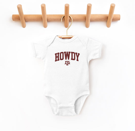 The White Infant Unisex Texas A&M Howdy Varsity Bodysuit lays flat on a white background. The ﻿Texas A&M Howdy Varsity﻿ graphic is in bold Maroon in a Collegiate style.