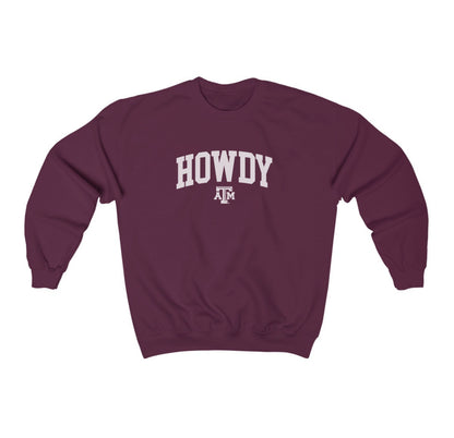 The Maroon Adult Unisex Texas A&M Howdy Varsity Crewneck Sweatshirt lays flat on a white background. The ﻿Texas A&M Howdy Varsity﻿ graphic is in bold White in a Collegiate style.