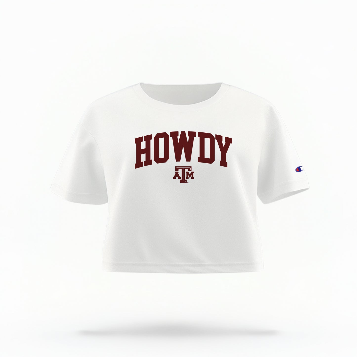 The White Adult Womens Texas A&M Howdy Varsity Crop Top lays flat on a white background. The ﻿Texas A&M Howdy Varsity﻿ graphic is in bold Maroon in a Collegiate style.