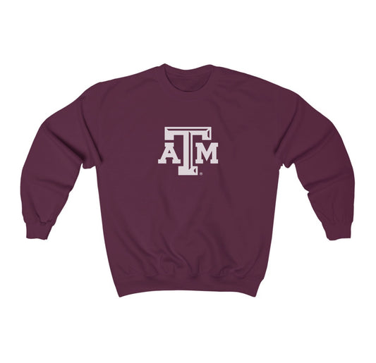 The Maroon Adult Unisex Texas A&M Logo Crewneck Sweatshirt lays flat on a white background. The ﻿Texas A&M Logo﻿ graphic is in bold White in a Varsity style.