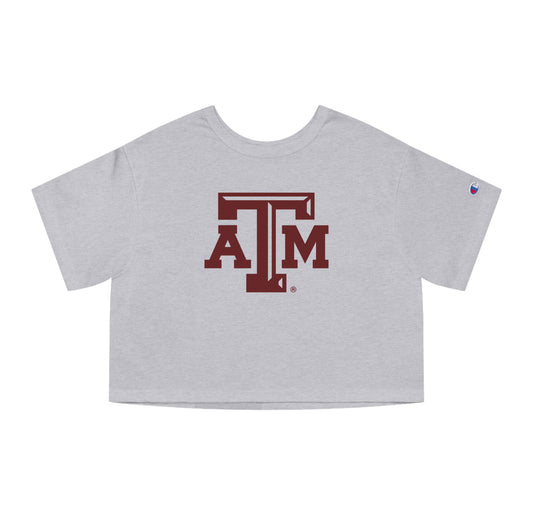 The Oxford Grey Adult Womens Texas A&M Logo Crop Top lays flat on a white background. The ﻿Texas A&M Logo﻿ graphic is in bold Maroon in a Varsity style.